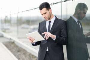 Businessman with tablet computer in office building